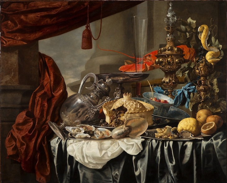 Opulent Still-Life with Silvergilt objects, Nautilus Shell, Porcelain, Pie, Fruit and Fish on a Draped Table