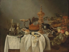 Still life with cake and gilded eel by Cornelis Kruys