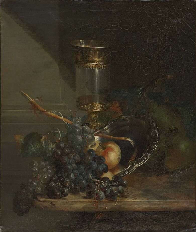 Still life with glass goblet and grapes on a marble table