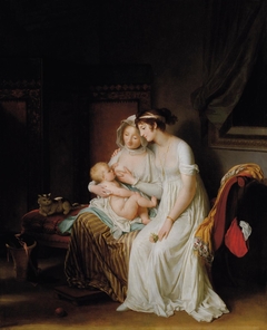 Une femme allaitant son enfant regardée par son amie