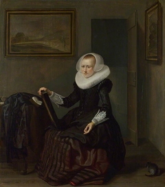 A Woman holding a Mirror by Pieter Codde