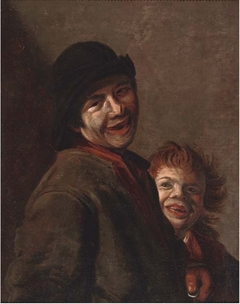 A young man with a coin in his hand and a child laughing