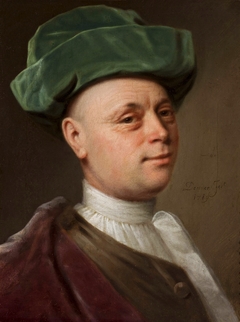 Portrait of a man in green hat.