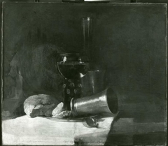 Still life with bread, a lemon, cups and a roemer on a pewter
