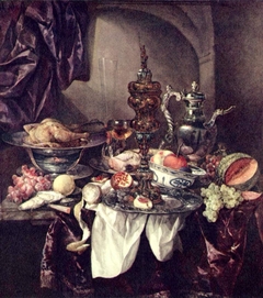 Still life with fruit, roast, silver- and glassware, porcelain and columbine cup on a dark tablecloth with white serviette