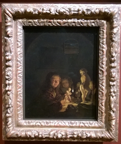 Two boys with plaster statuettes by the light of an oil lamp