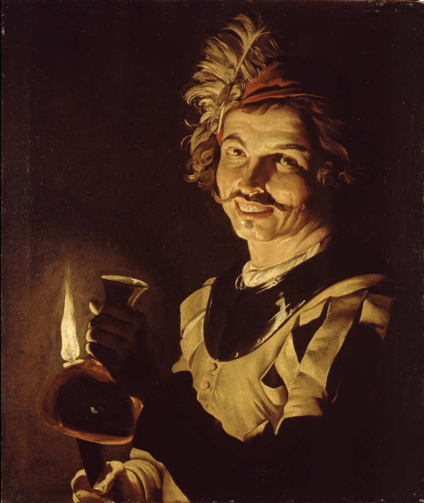 Young man with a decanter by candlelight