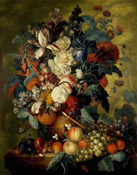 A vase of flowers with fruit