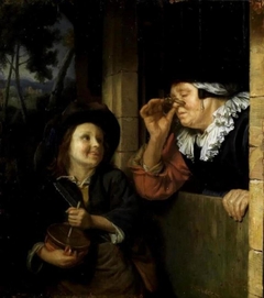 Young boy with a friction drum and an old woman by Godfried Schalcken