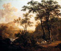 An extensive wooded river landscape with travellers on a rocky road, ruins and mountains beyond