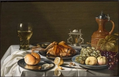 Still life with roemer, roast pheasant, salt-cellar, stoneware Jug, fruits and bread on a white cloth