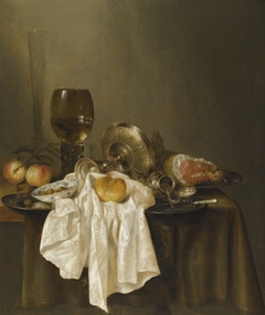 Still life with ham, mustard pot, bread, olives and roemer by Willem Claesz Heda