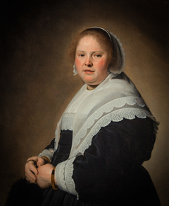 Portrait of an elegant woman in a black dress with a white lace collar