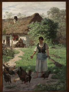 Village girl feeding hens