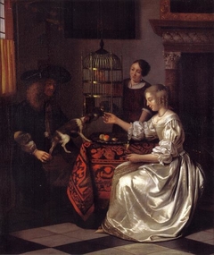 Young woman feeding a parrot, with a man and a serving woman