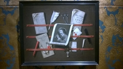 A trompe l'oeil of a letter rack with a print, a quill, sealing wax and a knife