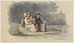 Familie zittend aan het water