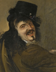 A laughing man wearing a black hat
