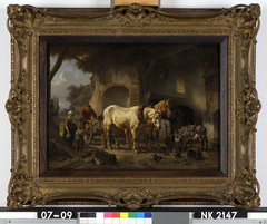 Interieur van een stal met boeren, ploegpaarden en een ezel by Wouterus Verschuur