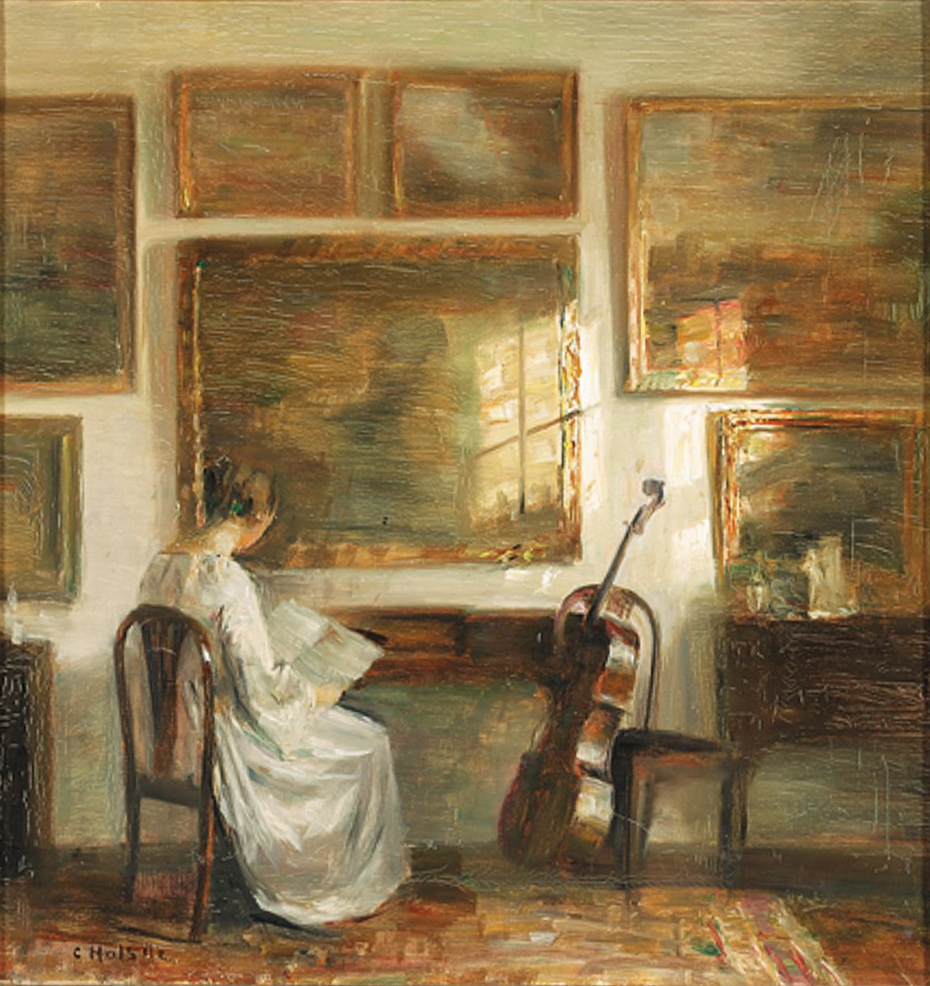 Woman at a table near a cello.