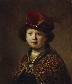 A boy in fanciful costume by Rembrandt