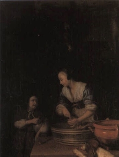 A woman making sausage with a boy and a dog by Godfried Schalcken