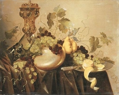 Still life with Akelei covered beaker, an upturned berkeyer resting on a nautilus shell, grapes, lemon and a knife