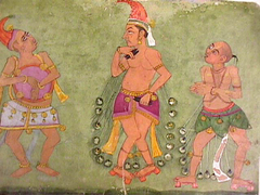 Two male dancers in peacock-feather robes, accompanied by a drummer by Anonymous