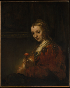 Woman with a Pink by Rembrandt